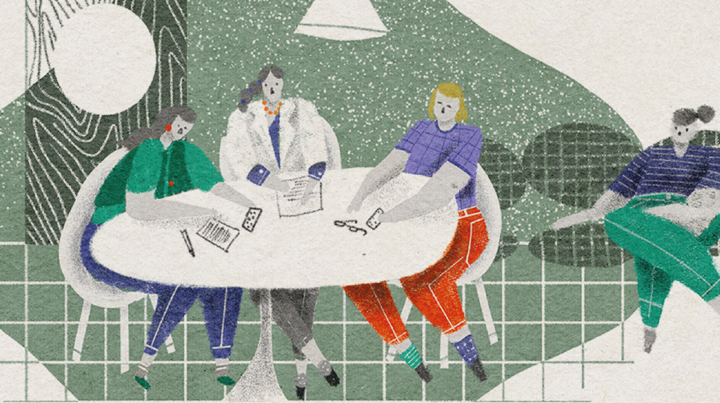 [Ilustración de Lucía Seisas] En una mesa, una enfermera y una médica dialogan y proveen medicamentos a una persona con síndrome de down, a quien se identifica porque tiene dos medias diferentes. Detrás, se encuentra la persona acompañante. 